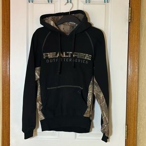 Black camo hoodie, Realtree brand, has a zip up hidden pocket, size M